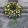 Funeral wreath, white roses and ribbon